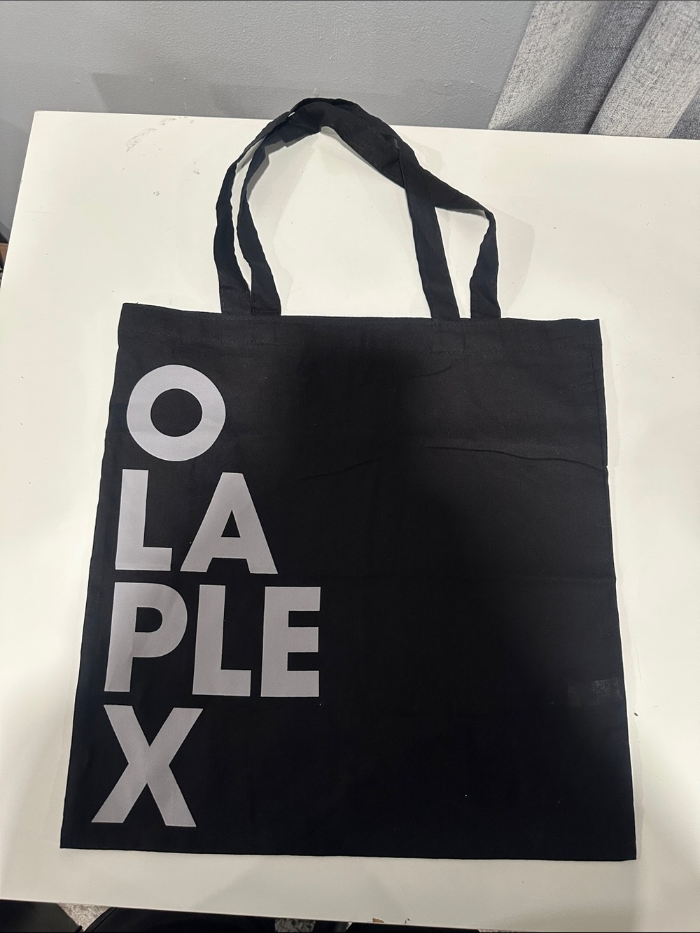 OLAPLEX Black Tote with gray Vertical Logo